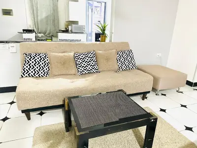 a living room with a couch and a table at Lima Modern. Sea View. Strong Wi Fi. Sheraton Road in Hurghada