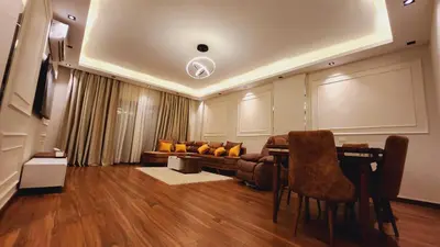 a living room with a table and a couch at Sphinx Luxor Apartment in Luxor