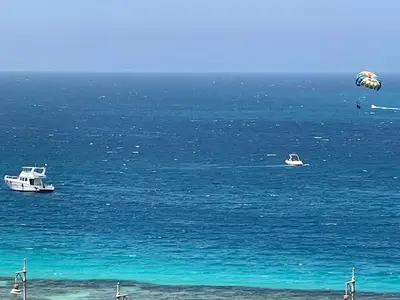 two boats in the ocean with a kite in the sky at Marvel flat in Hurghada