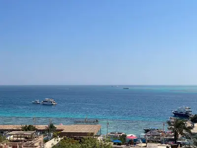 a view of a beach with boats in the water at Marvel flat in Hurghada