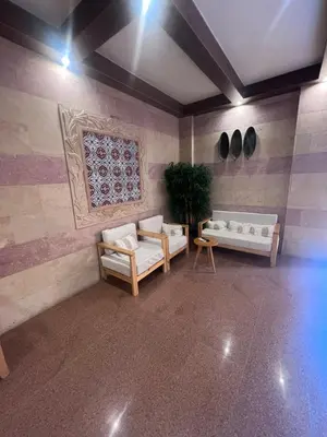 a room with two couches and a painting on the wall at Boho Homes in Hurghada