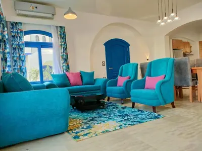 a living room with blue chairs and a blue couch at Amaros Sahl Hasheesh sea view Villa with Pool سهل حشيش in Hurghada