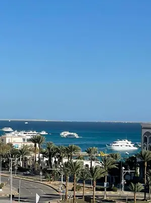 a view of the ocean and boats in the water at AlDAU Heights Modern Brand New Apartments in Hurghada