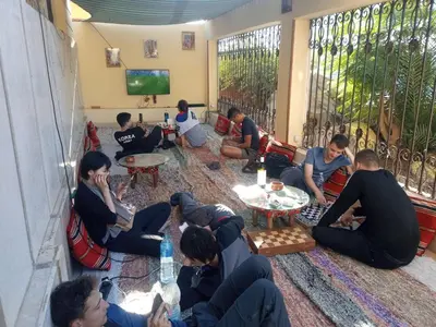 a group of people sitting on the floor in a living room at Go Inn Backpackers in Aswan