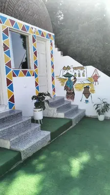 a building with stairs and a painting on the wall at Go Inn Backpackers in Aswan