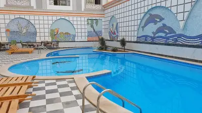 a large swimming pool with a tile wall at 304 الشيراتون بلازا in Hurghada