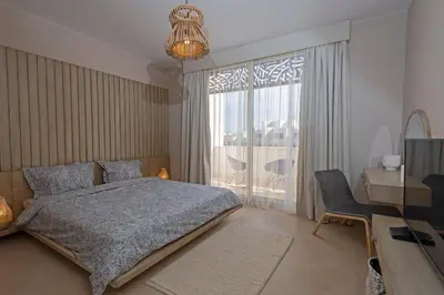 a bedroom with a bed and a desk and a window at A Stunning Seaview Penthouse; 3bedrooms + nanny in Hurghada