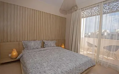 a bedroom with a bed and a large window at A Stunning Seaview Penthouse; 3bedrooms + nanny in Hurghada