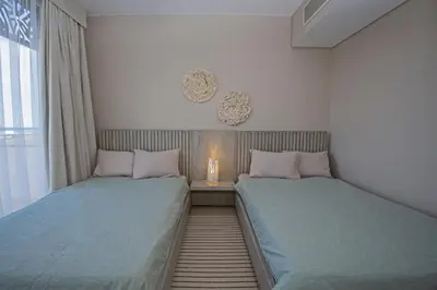 two beds sitting next to each other in a bedroom at A Stunning Seaview Penthouse; 3bedrooms + nanny in Hurghada