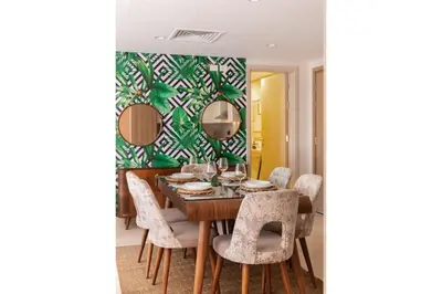 a dining room with a table and chairs at Balanced & Bright 2 BDR Mangroovy Free Pool & Beach Access in Hurghada