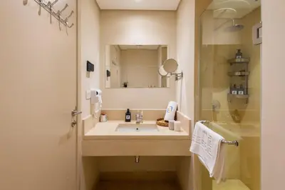 a bathroom with a sink and a shower at Chilled & Serene 1BDR Mangroovy Pool & Sea View in Hurghada