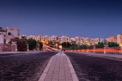 a city street at night with buildings at Chilled & Serene 1BDR Mangroovy Pool & Sea View in Hurghada