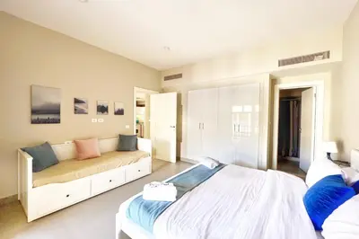 a large bedroom with a bed and a couch at Minimal & Central 1BDR Apt Abu Tig Marina in Hurghada