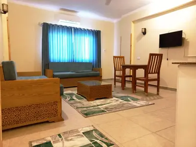 a living room with a couch and a table at Embrace Guest House in Luxor