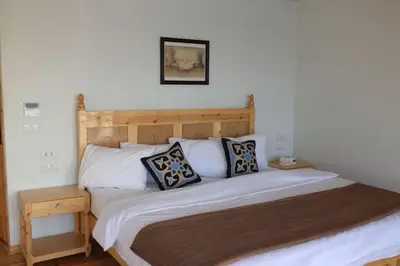 a bed with two pillows on it in a bedroom at Embrace 1 Nile Sailing Dahabiya in Luxor