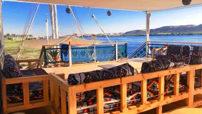 a boat filled with bottles of wine on the water at Embrace 1 Nile Sailing Dahabiya in Luxor
