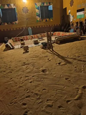 a room with footprints in the sand and a stage at Miral Nubian House in Aswan