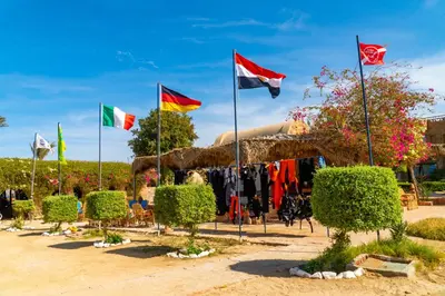 a group of flags in front of a tent at Utopia Beach Club in Marsa Alam City