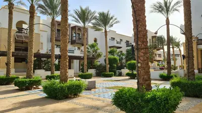 a resort with palm trees and buildings at Babel Apartments Hotel El Gouna in Hurghada
