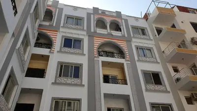 a tall white building with balconies and windows at sheraton blaza307 in Hurghada