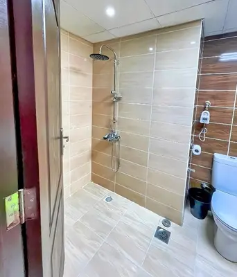 a bathroom with a shower and a toilet at Florenza Blue Sky & Poolview Studio Hurghada in Hurghada