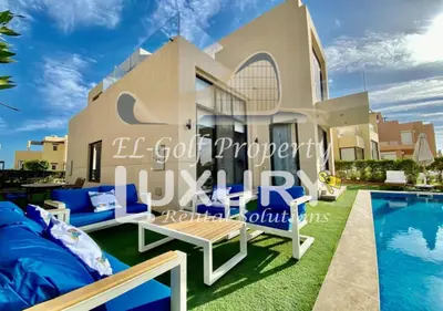 a villa with a swimming pool in front of it at Tawila Villa T1-15 in Hurghada