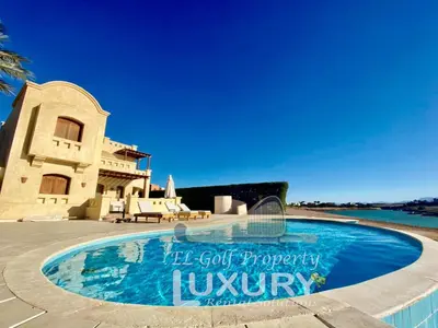 a swimming pool in front of a house at Private Villa Y51 - 3 BedRooms at El-Gouna in Hurghada