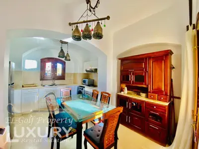 a kitchen with a table with chairs and a sink at Private Villa Y51 - 3 BedRooms at El-Gouna in Hurghada