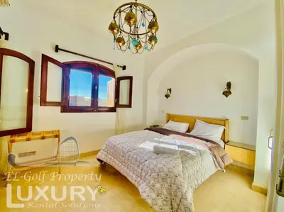 a bedroom with a bed and a chandelier at Private Villa Y51 - 3 BedRooms at El-Gouna in Hurghada