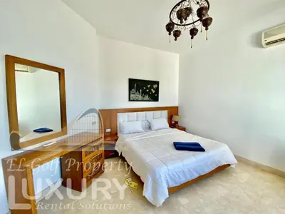 a bedroom with a bed and a desk and a mirror at Villa 9 ph-5 with 4 Bed Room in Hurghada
