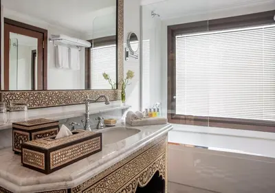 a bathroom with a sink and a large mirror at Dahabeya Molouky Nile Cruise- Every Monday from Luxor- Aswan for 05 nights in Luxor