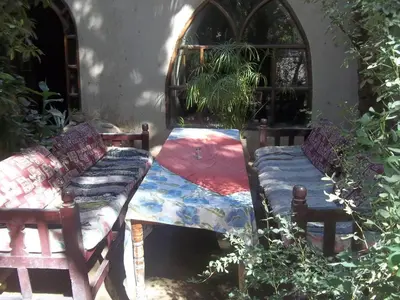 a couple of beds sitting next to a building at Nour El Gourna in Luxor