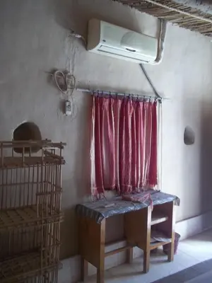 a room with a window with a red curtain at Nour El Gourna in Luxor