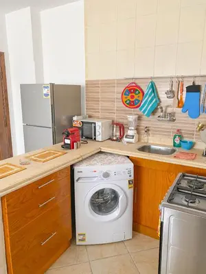a kitchen with a washing machine and a sink at Modern Mountain View on The Touristic Promenade in Hurghada