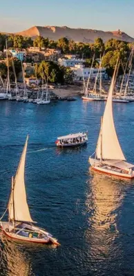 two boats with sails in a body of water at One Love Guesthouse & Restaurant in Luxor