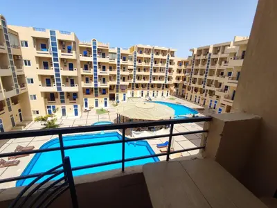 a view from the balcony of a apartment with a swimming pool at Tiba Resort F22 Near to ElGouna in Hurghada