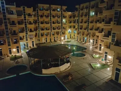 an aerial view of a building with a swimming pool at night at Tiba Resort F22 Near to ElGouna in Hurghada