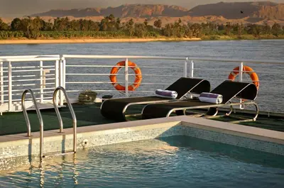 a swimming pool on the deck of a boat in the water at Le Fayan Nile Cruise - Every Monday from Luxor for 4 & 7 Nights, and every Friday from Aswan for 3 & 7 Nights in Luxor