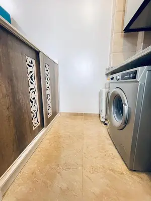 a laundry room with a washing machine in it at Cozy Apartment in Qadd el-Barûd