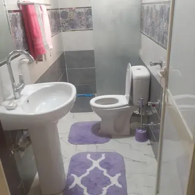 a bathroom with a toilet and a sink at Hossam Deluxe Apartment El Hadaba Sheraton in Hurghada