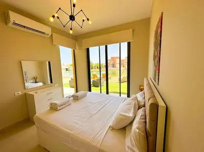 a bedroom with a large bed with a large window at Luxury 3 bedrooms town house in Hurghada