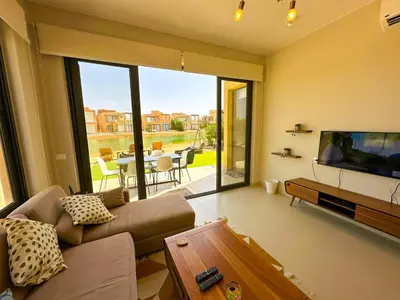 a living room with a couch and a flat screen tv at Luxury 3 bedrooms town house in Hurghada