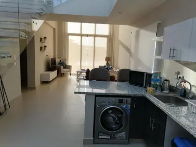 a kitchen with a washing machine in a kitchen at Tawila, 4 Bedroom Villa, Brand new, directly on a lagoon in Hurghada