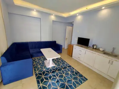 a living room with a blue couch and a table at La Boutique Residence in Hurghada