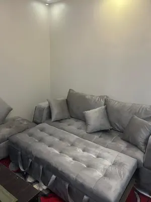 a gray couch in a living room at Hossam Comfort Apartment El Hadaba Hurghada in Hurghada