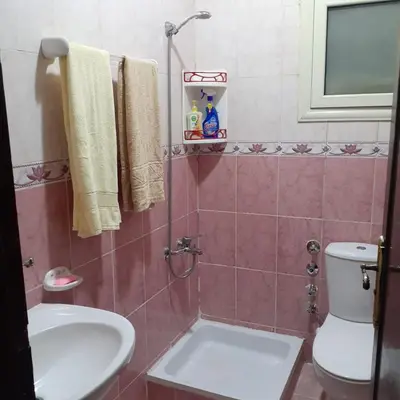 a bathroom with a toilet and a sink at Hossam Comfort Apartment El Hadaba Hurghada in Hurghada
