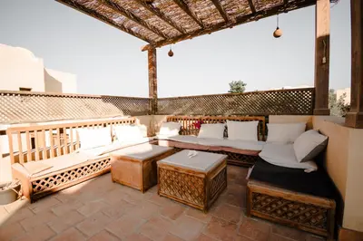 a patio with couches and tables on a roof at Modern Villa in El Gouna (Private Pool & Garden.) in Hurghada