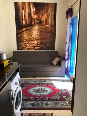a living room with a couch and a rug at Red Sea Tiba plaza Apartment in Hurghada