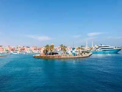 a small island in the middle of the water with boats at Red Sea Tiba plaza Apartment in Hurghada