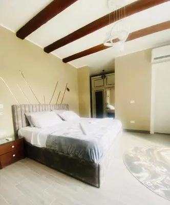 a bedroom with a large bed and a ceiling at LuxVilla 1 BHK W Private Heated Pool in Bali El Gouna in Hurghada